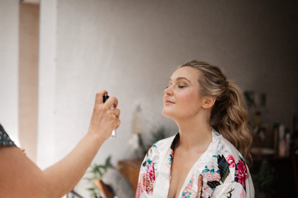 Bride having wedding day makeup applied